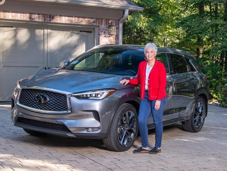 Susie Everett standing next to an Infiniti car