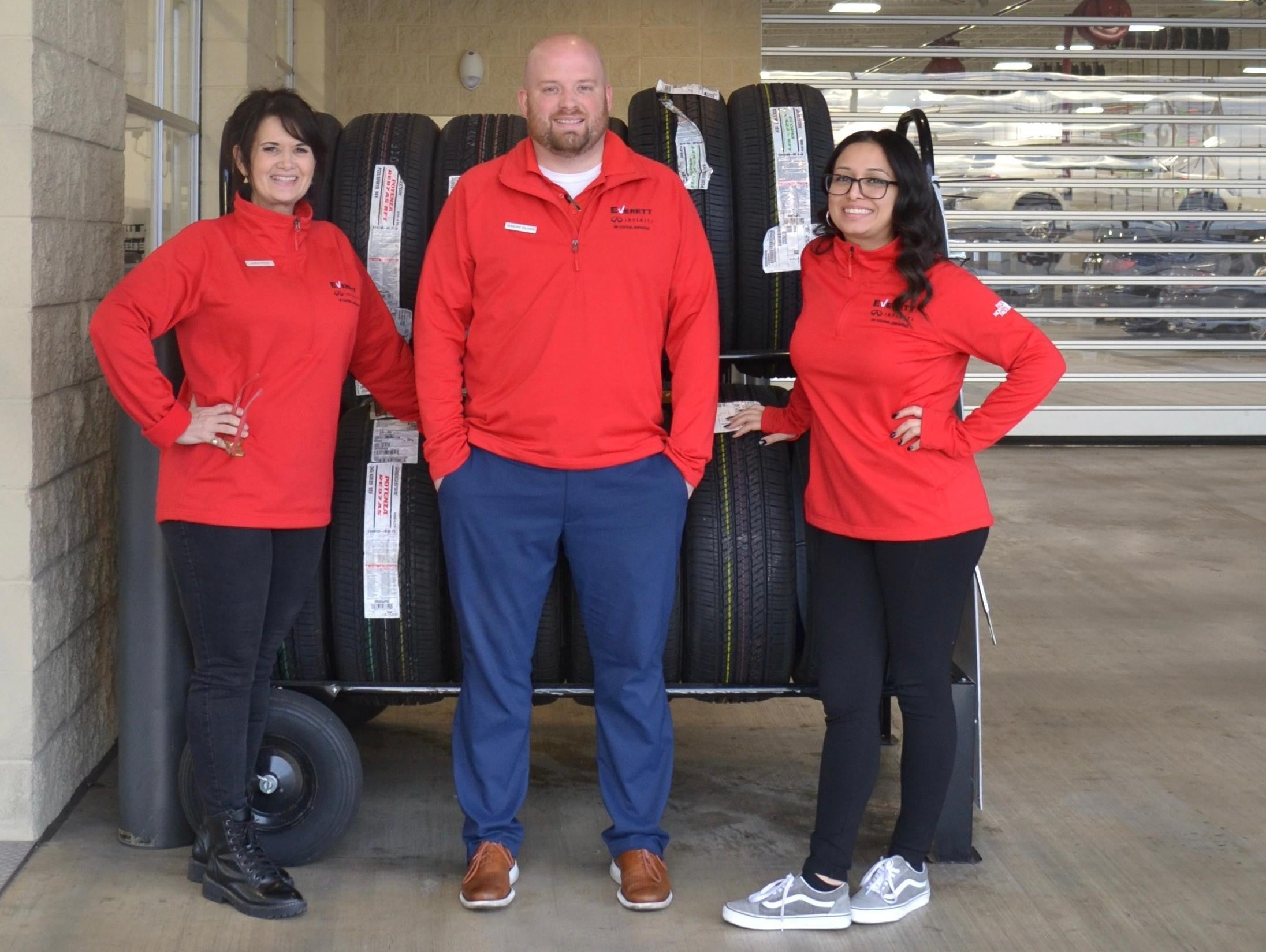 Service employees standing near a tire rack
